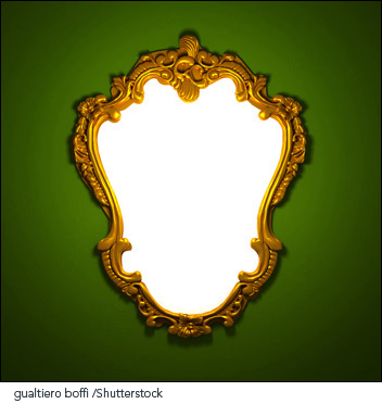 Ornate mirror on a green wall